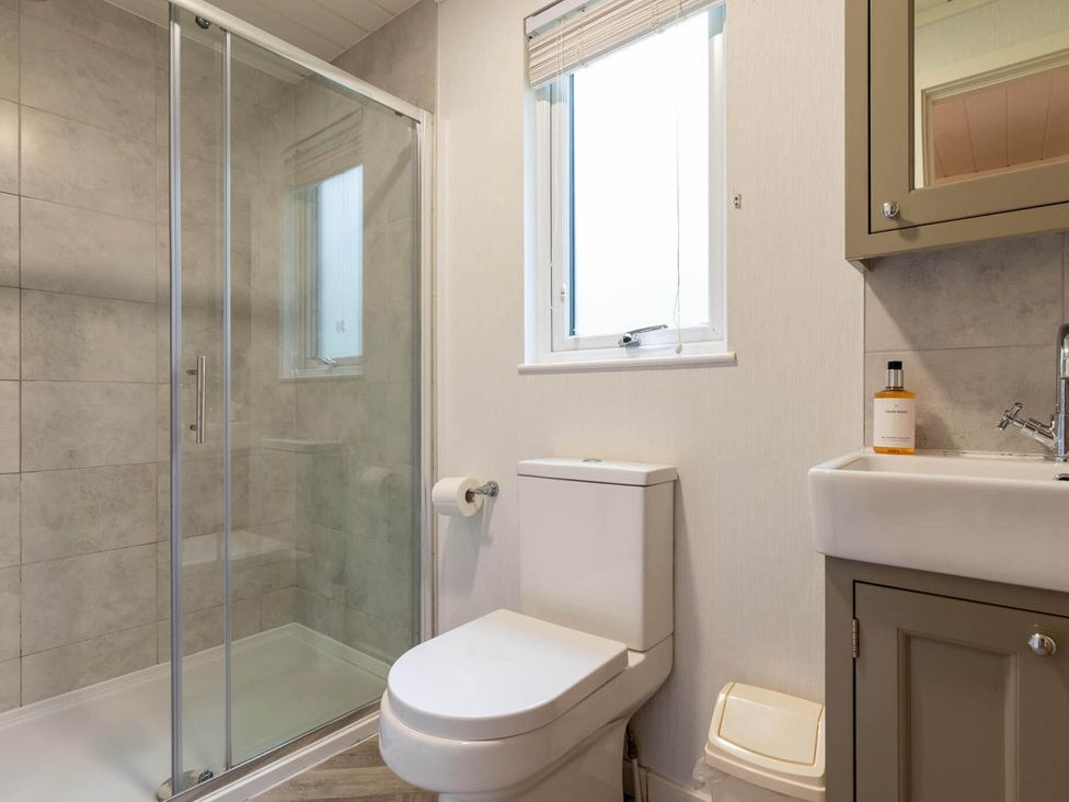 A bathroom with a shower, toilet, and sink at Wensleydale in Aysgarth