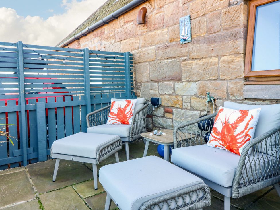 An outdoor area with chairs and a table at Bridle Cottage in Cockburnspath