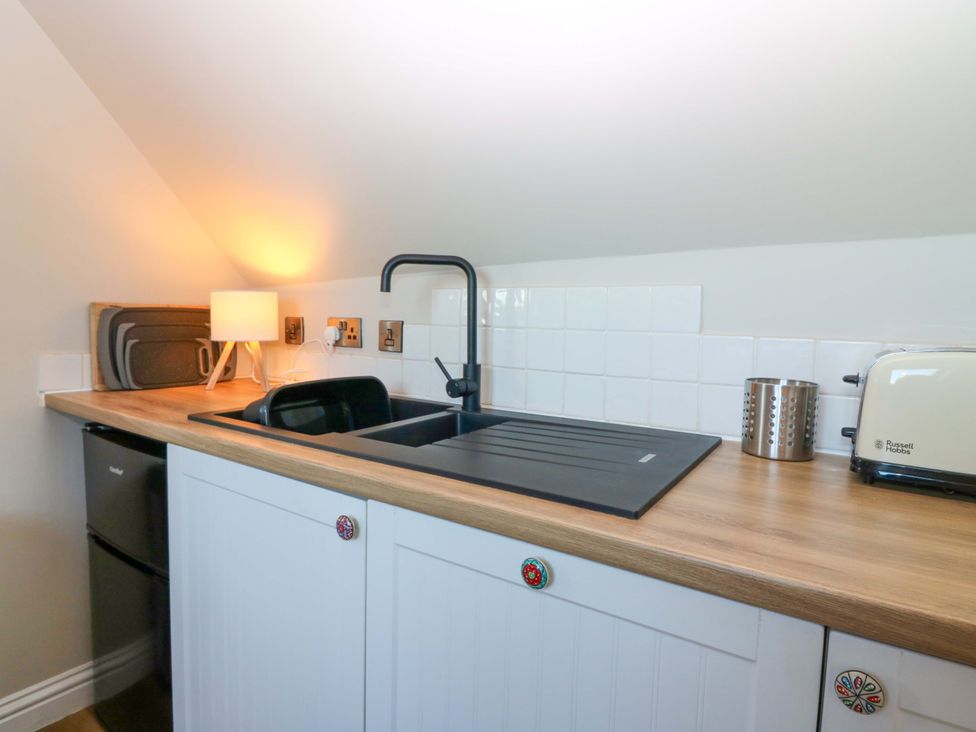 A kitchen with a sink and countertop at Bridle Cottage in Cove