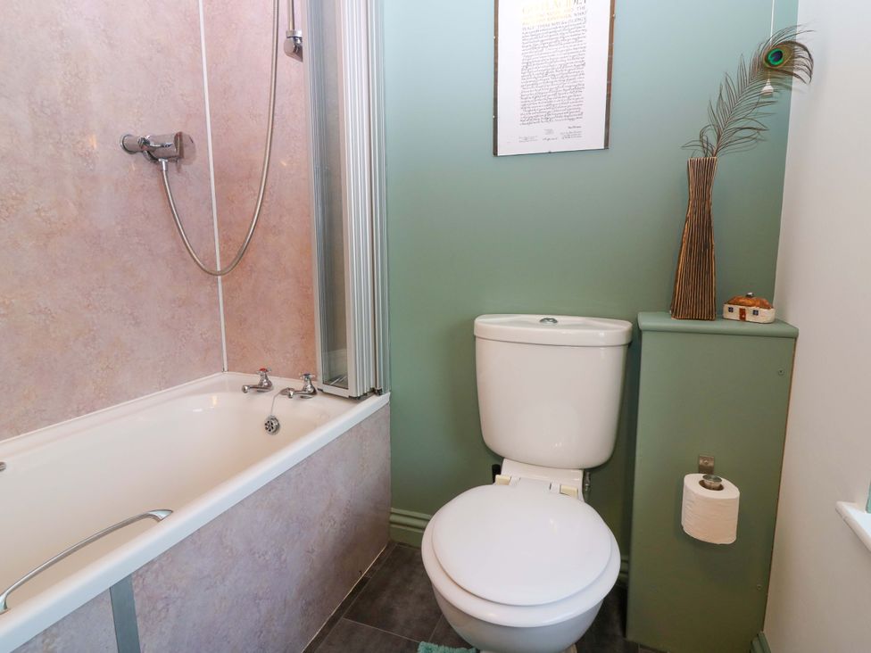 A bathroom with a bathtub and shower at Bridle Cottage in Cove