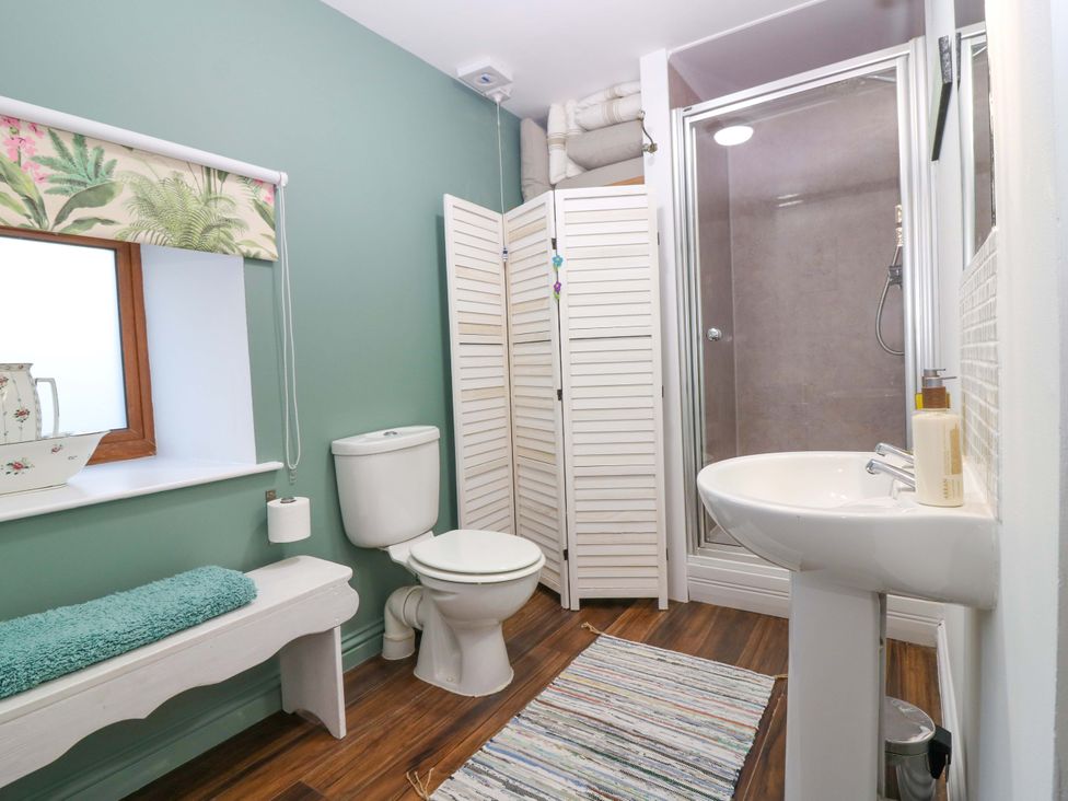 A bathroom with shower and sink at Bridle Cottage in Cove
