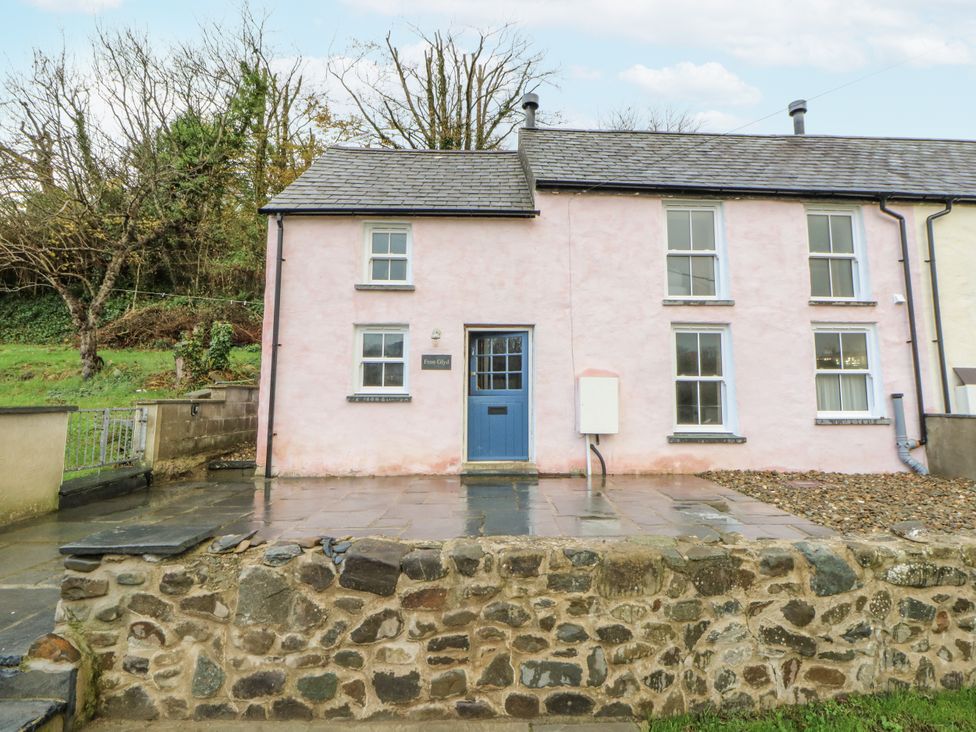 A house with blue door and stone wall at Fronglyd Aberporth