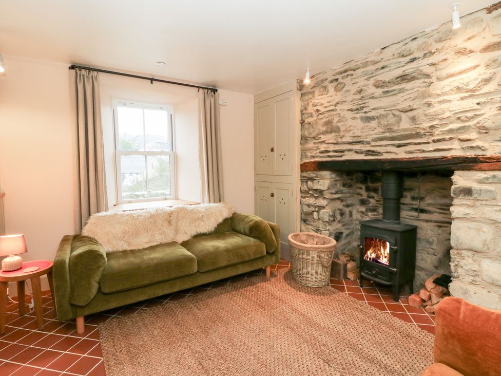 A living room with a fireplace and sofa at Fronglyd Aberporth