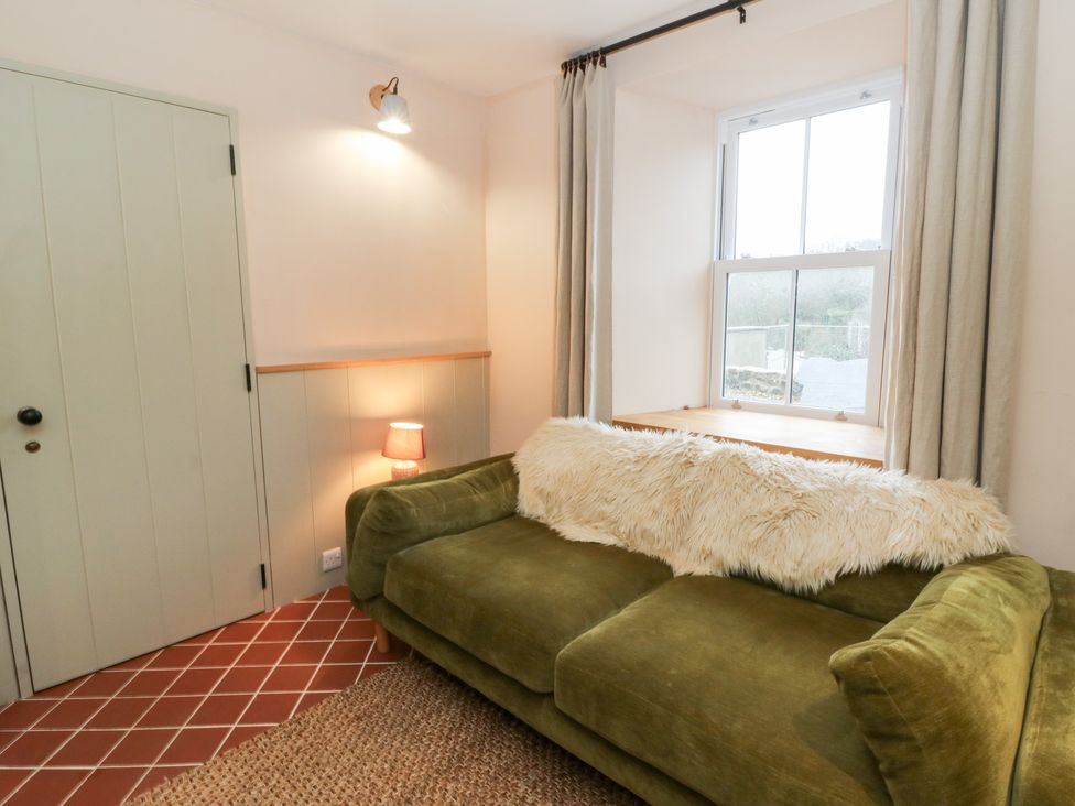 A living room with a couch and lamp at Fronglyd in Aberporth