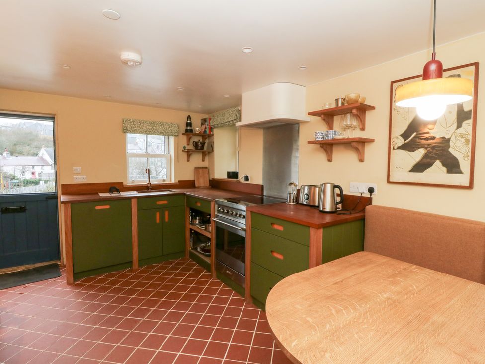 A kitchen with a stove and sink at Fronglyd Aberporth