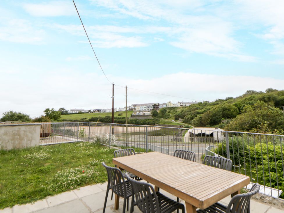 An outdoor area with a table and chairs at Fronglyd Aberporth