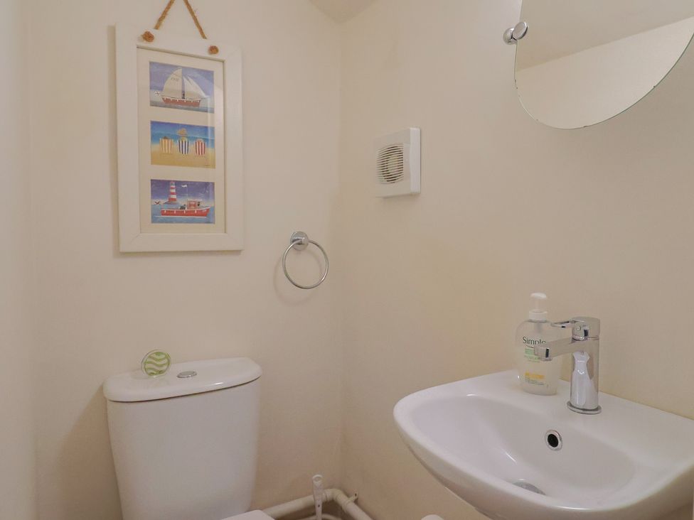 A bathroom with toilet and sink at Vine Cottage in Burton Bradstock
