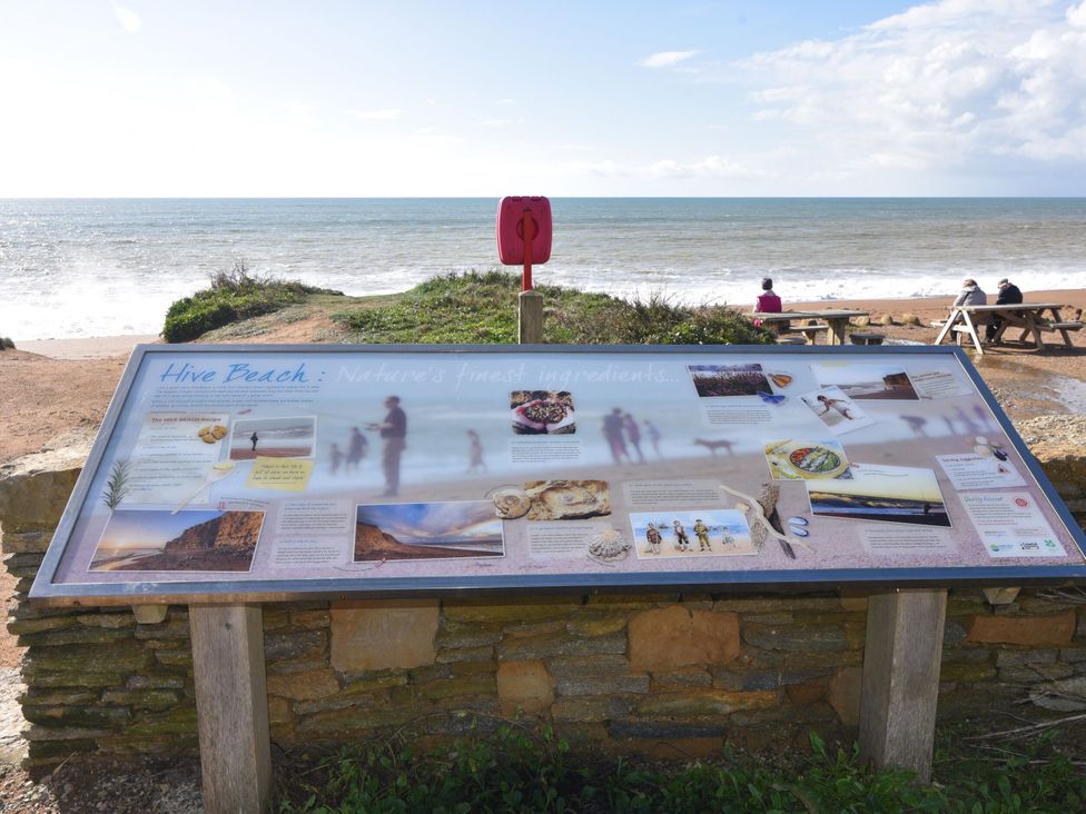 An information board by the beach at Hive Beach in Burton Bradstock