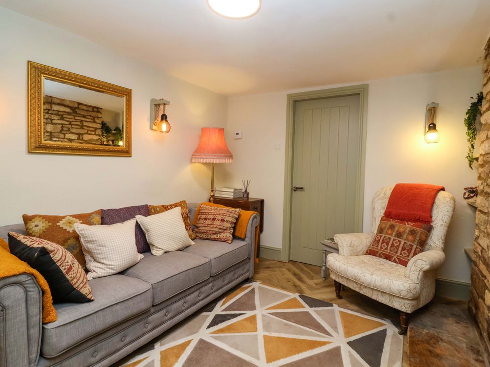 A living room with a sofa and armchair at 29 Spring Street Chipping Norton