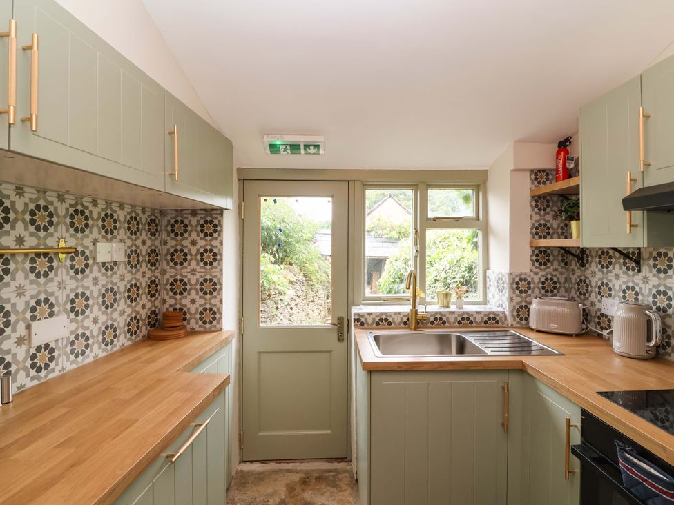 A kitchen with cabinets and a sink at 29 Spring Street in Chipping Norton