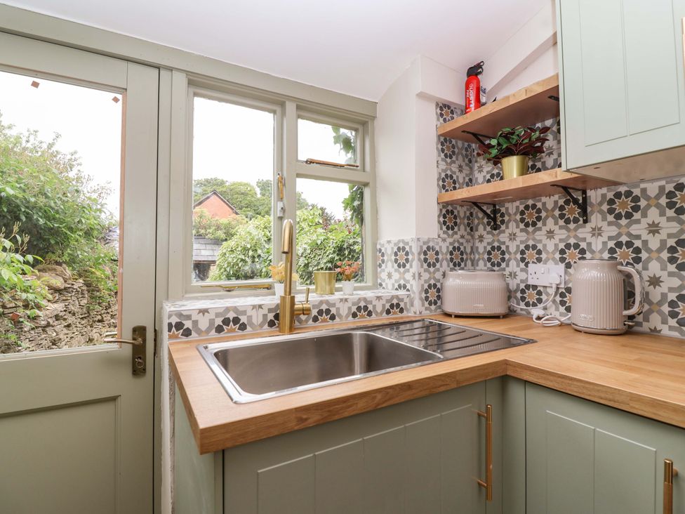 A kitchen with sink and wooden countertop at 29 Spring Street Chipping Norton