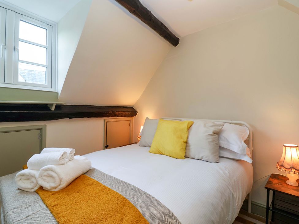 A bedroom with a bed and pillows at 29 Spring Street, Chipping Norton