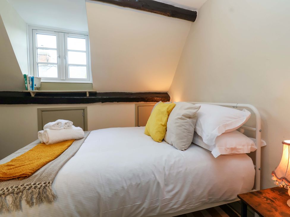 A bedroom with a bed and window at 29 Spring Street in Chipping Norton