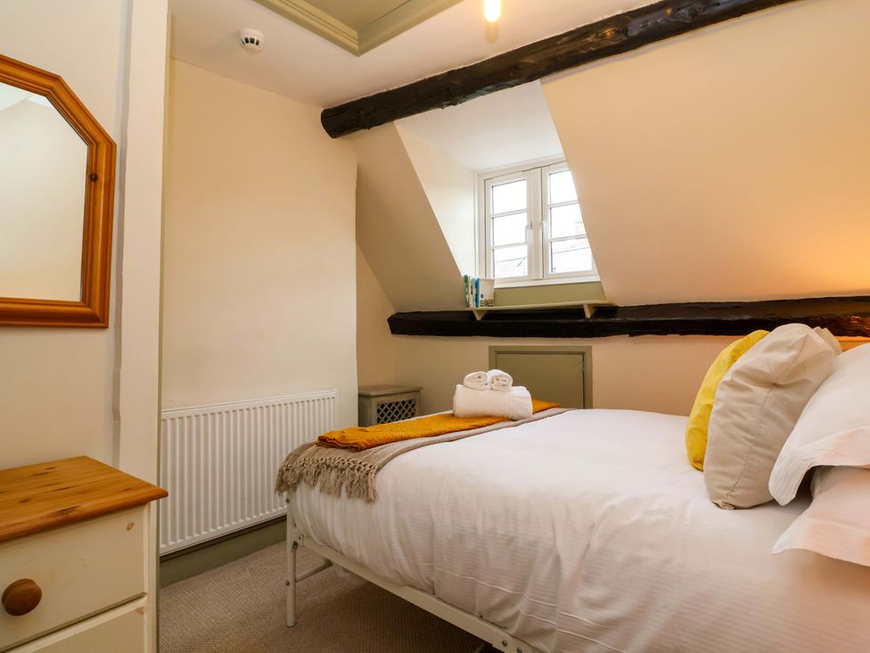 A bedroom with a bed and window at 29 Spring Street Chipping Norton