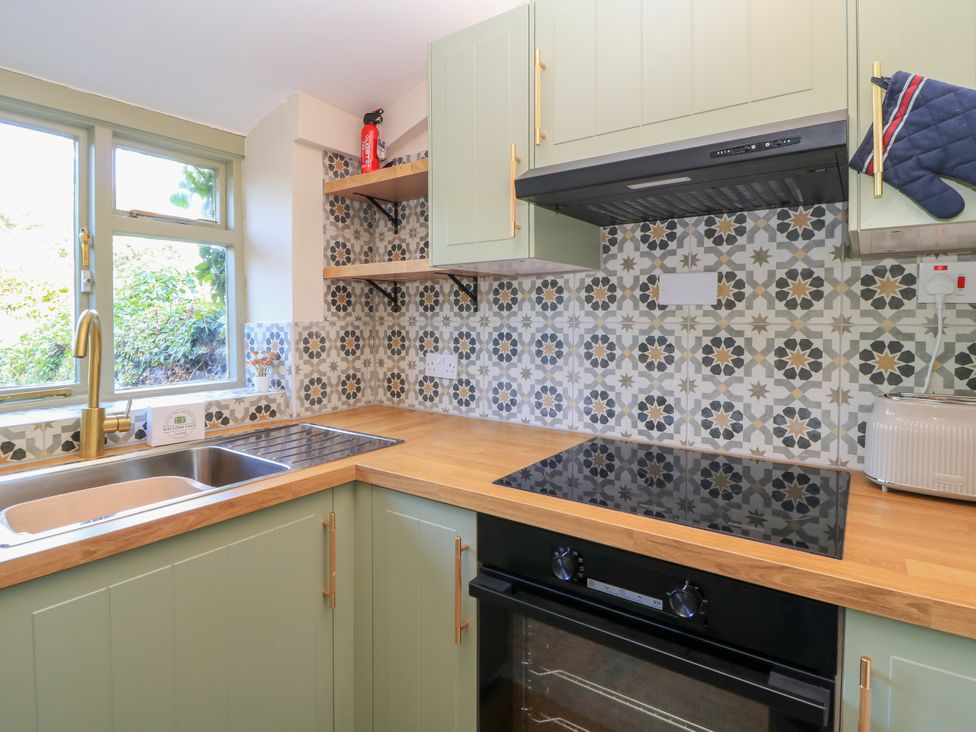 A kitchen with cabinets and a stove at 29 Spring Street in Chipping Norton