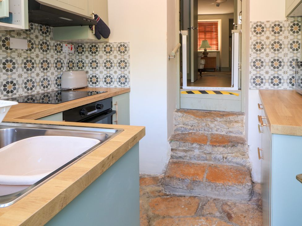 A kitchen with a sink and stove at 29 Spring Street in Chipping Norton