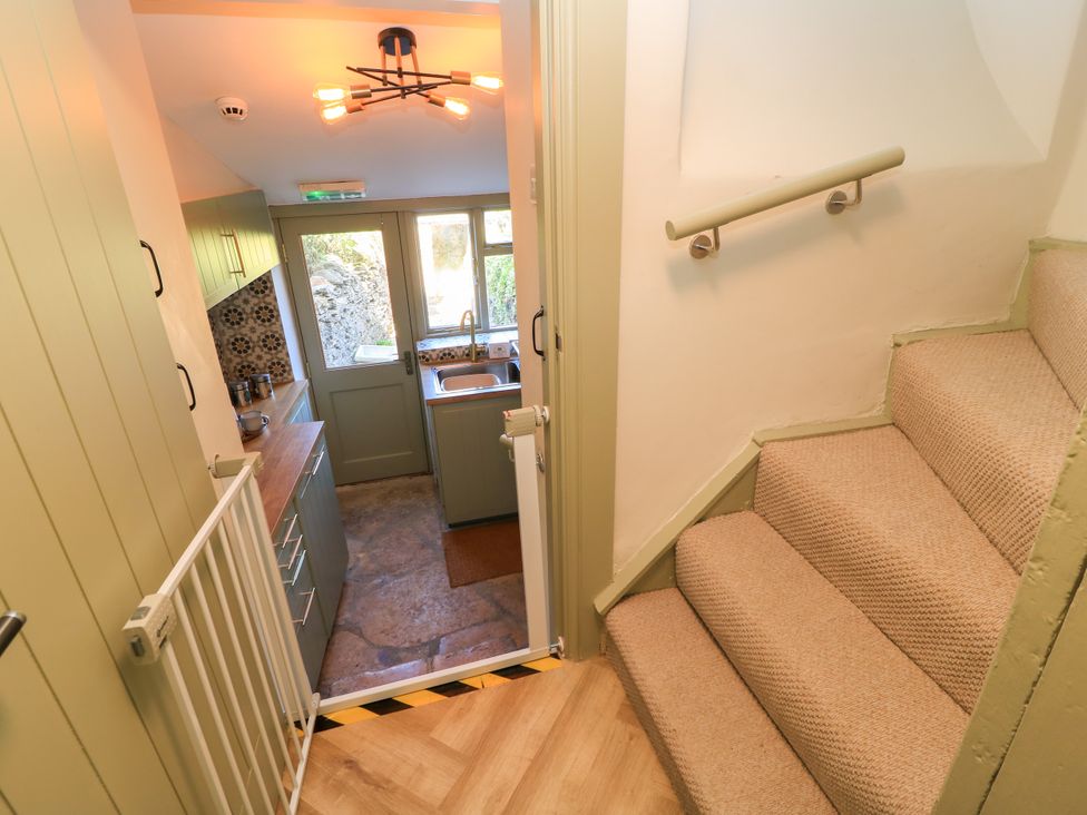 A kitchen with a sink and stairs at 29 Spring Street Chipping Norton