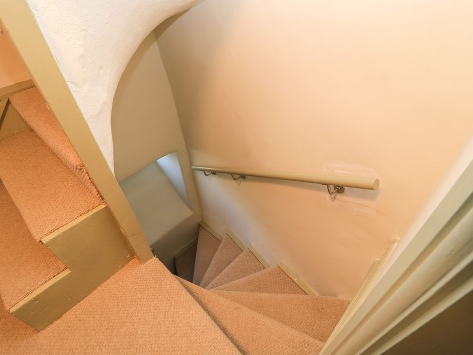A staircase with carpet and handrail at 29 Spring Street in Chipping Norton
