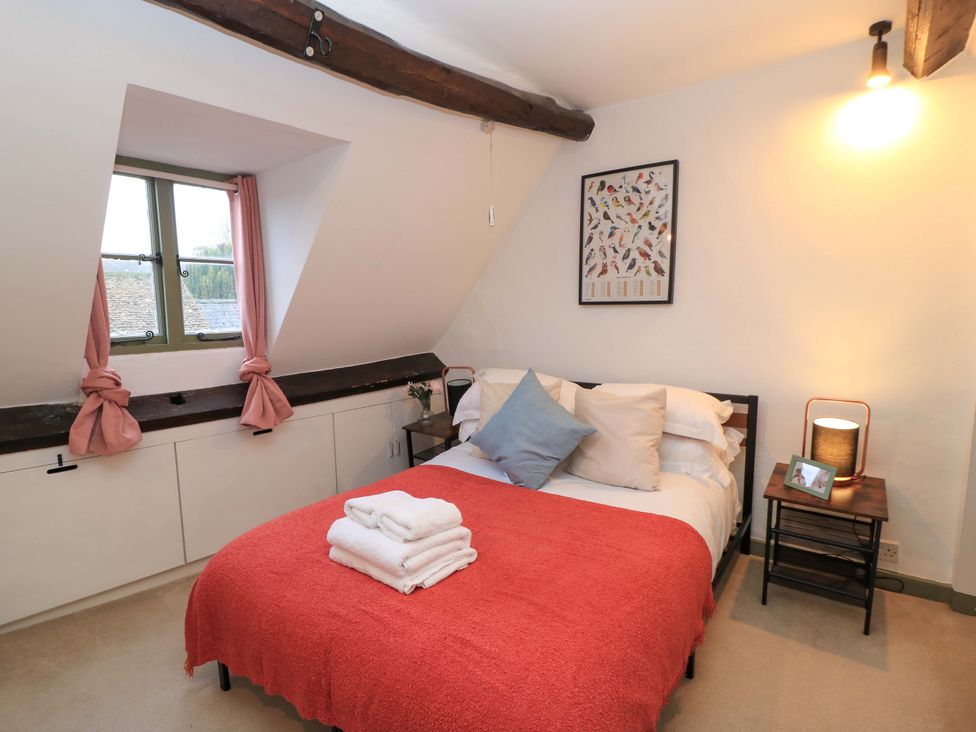 A bedroom with a bed and storage cabinets at 6 Priory Lane Burford