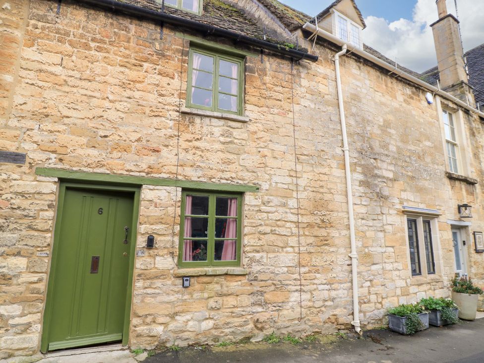 An exterior view of a stone cottage with door and windows at 6 Priory Lane Burford