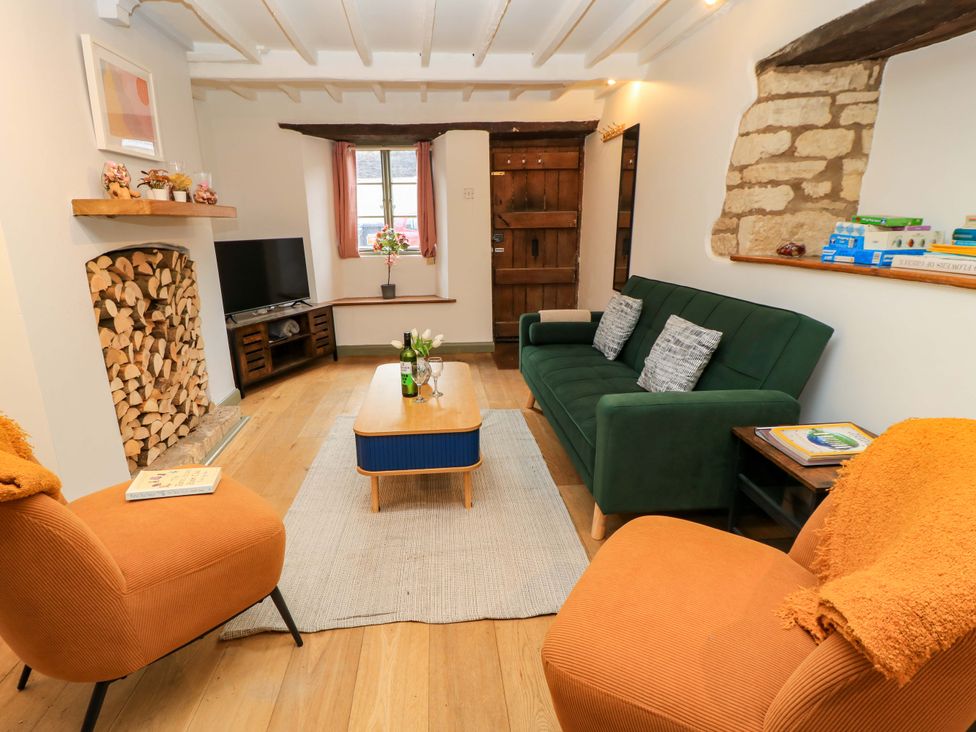 A living room with a sofa, coffee table, and television at 6 Priory Lane Burford