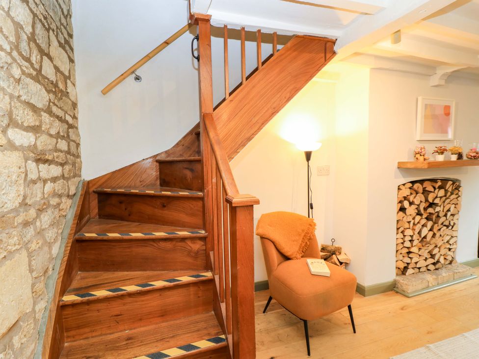 An entryway with a staircase and armchair at 6 Priory Lane Burford