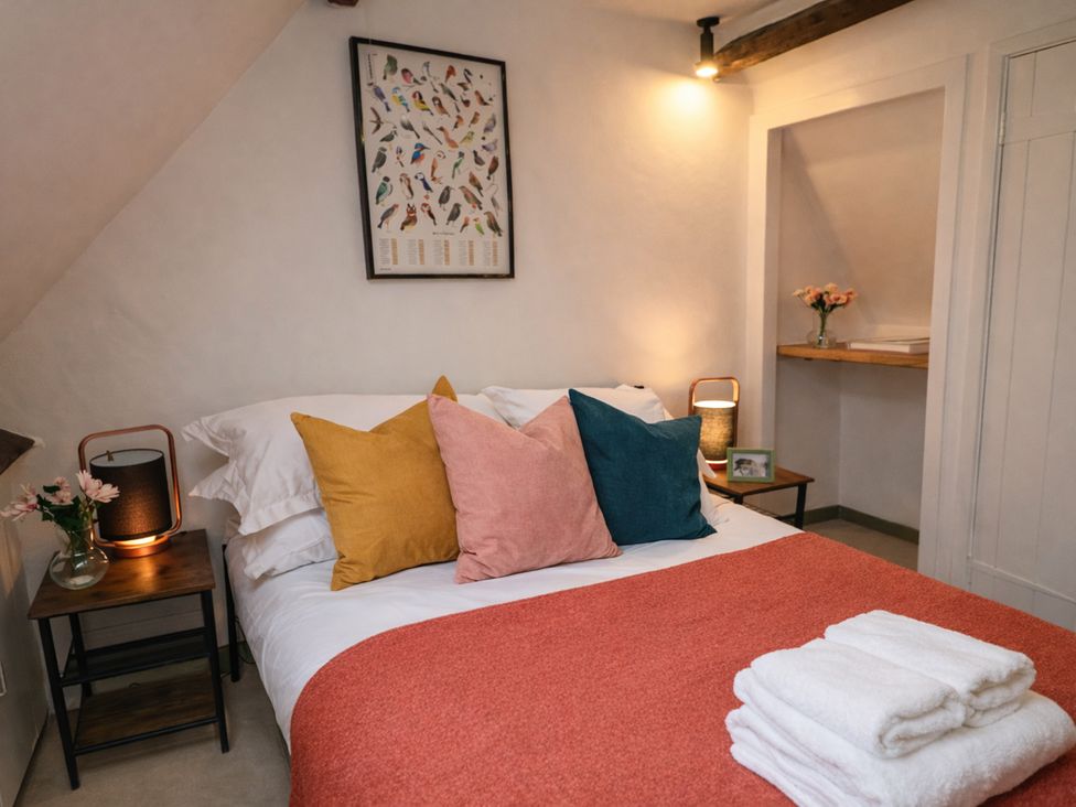 A bedroom with a bed and nightstand at Burford Apple in Burford