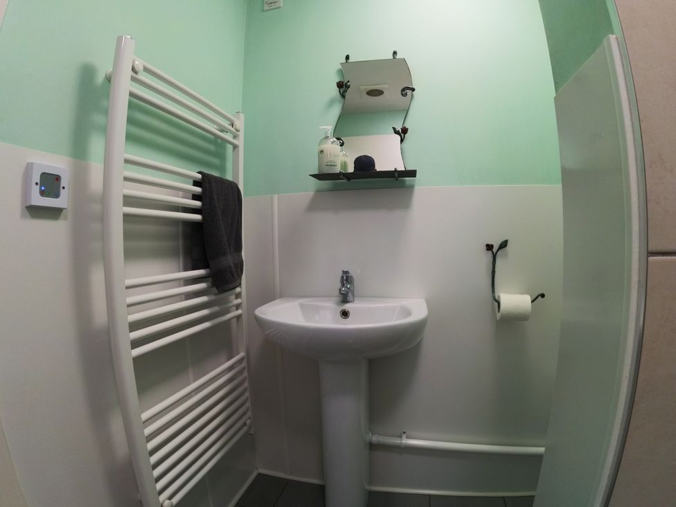 A bathroom with a sink and towel radiator at Rosebud Meadow Pod 1