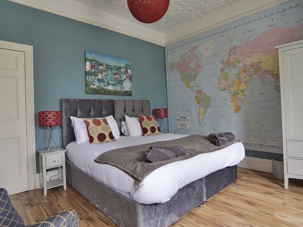 A bedroom with a bed and map wall art at Roselyn House in Par