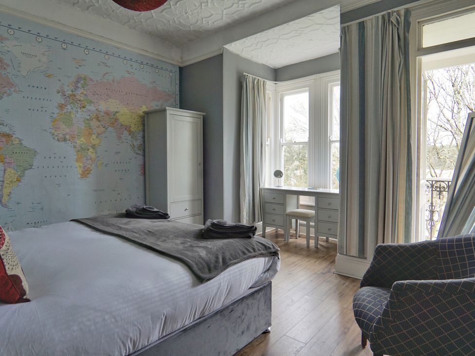 A bedroom with a map on the wall and a desk at Roselyn House in Par