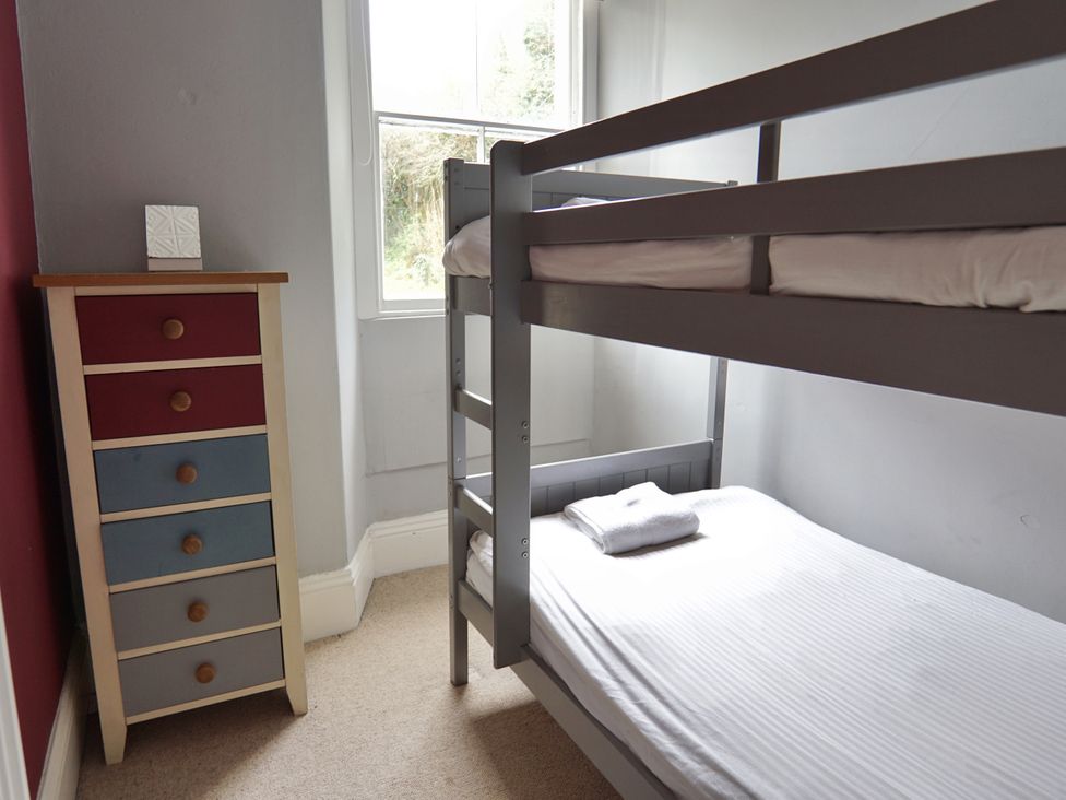 A bedroom with a bunk bed and a chest of drawers at Roselyn House in Par