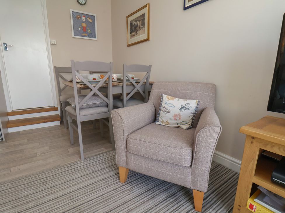 A dining room with a table and chairs at Farriers Yard in Whitby