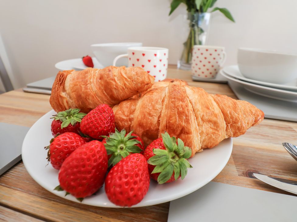 A plate with croissants and strawberries at Farriers Yard Whitby