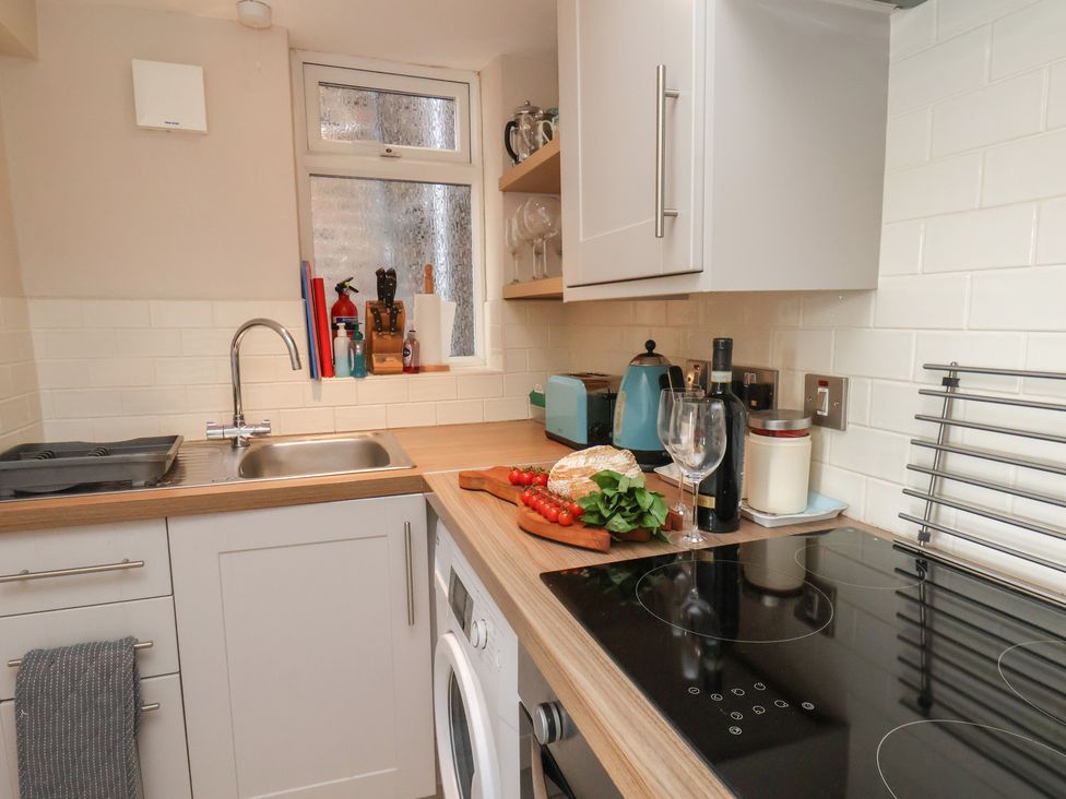 A kitchen with a sink and appliances at Farriers Yard in Whitby