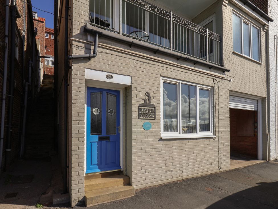 A front entrance with blue door and balcony at Farriers Yard in Whitby