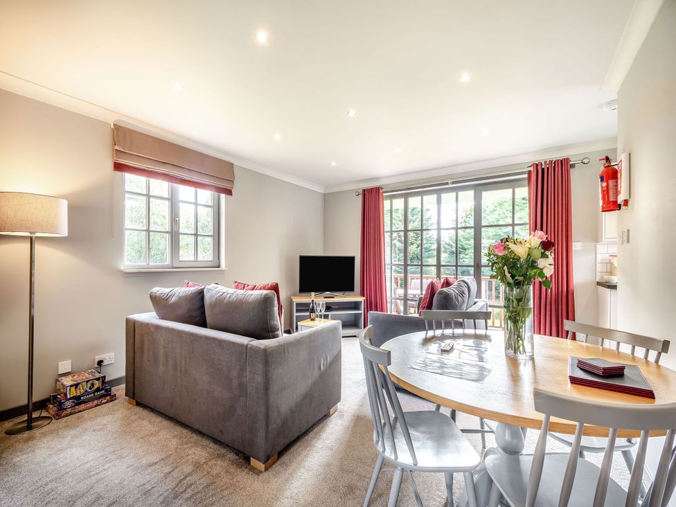 A living room with a sofa and television at Bargany in Girvan
