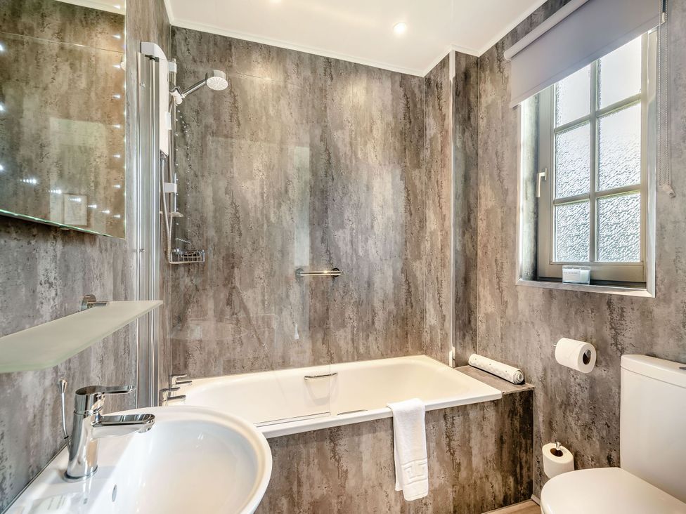 A bathroom featuring a bathtub, shower, sink, and toilet at Bargany in Girvan