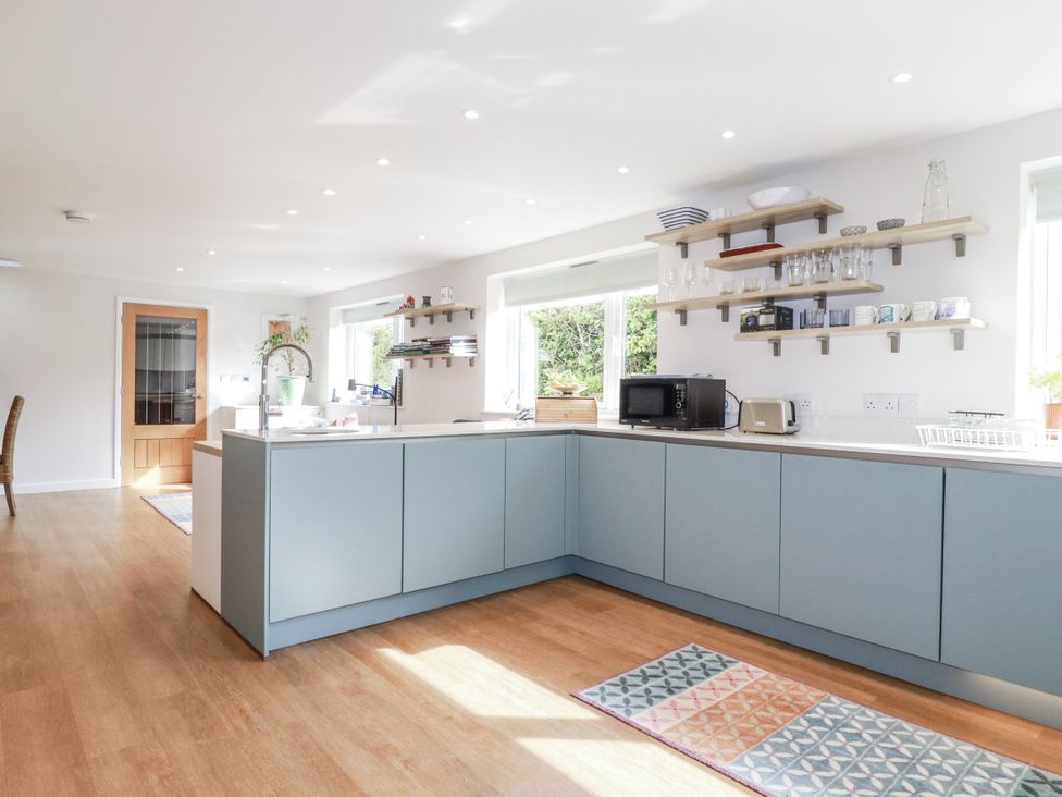 A kitchen with cabinets and appliances at Hillbre in Trevone