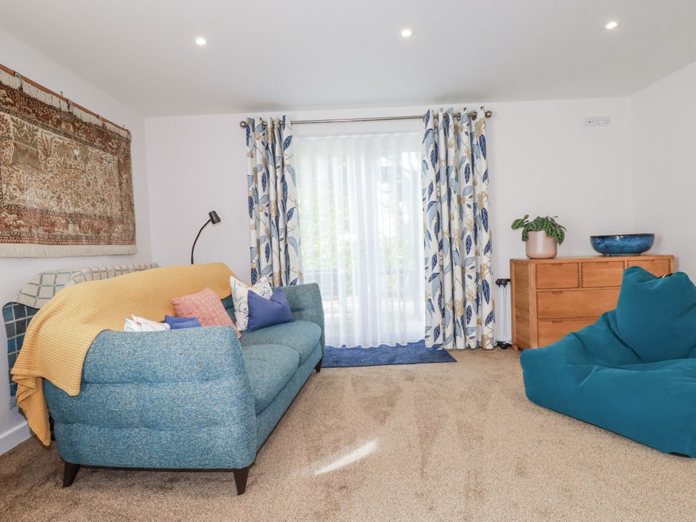 A living room with a sofa and curtains at Hillbre in Trevone