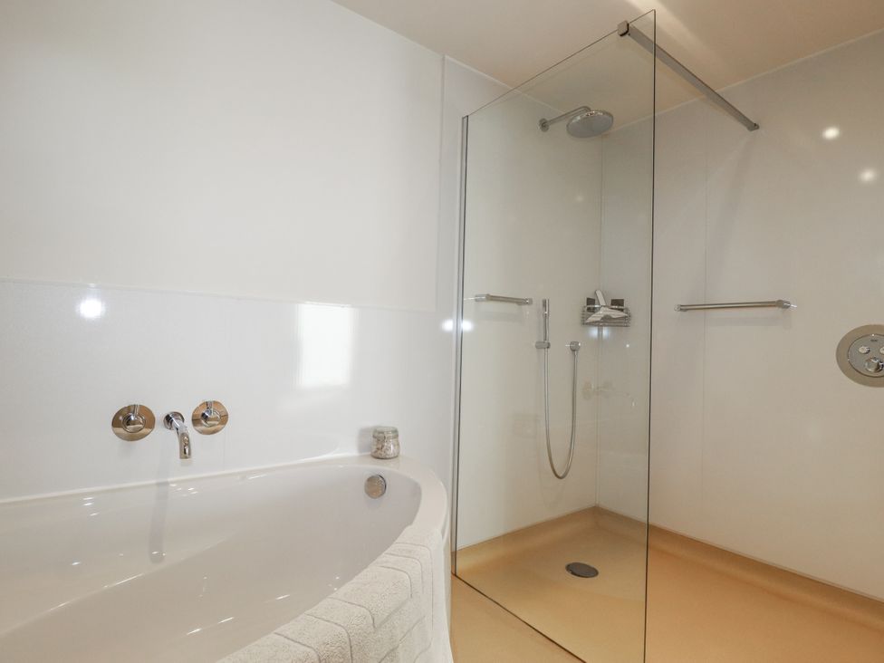 A bathroom with a bath tub and shower at Hillbre in Trevone