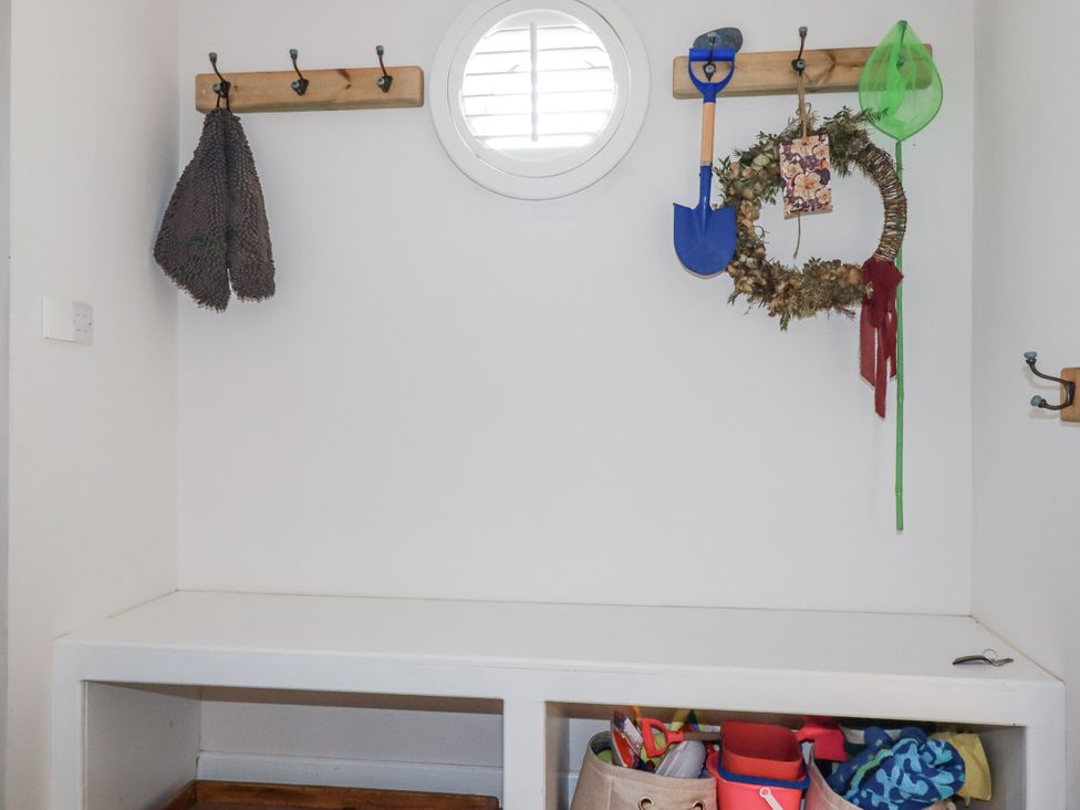 An entryway with hooks and a bench at Hillbre in Trevone