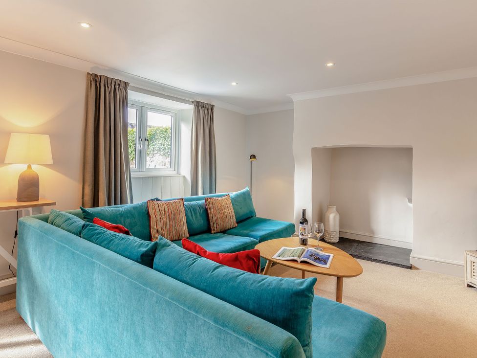 A living room with a sofa and coffee table at Summerleaze Cottage 2 Spa in Bude