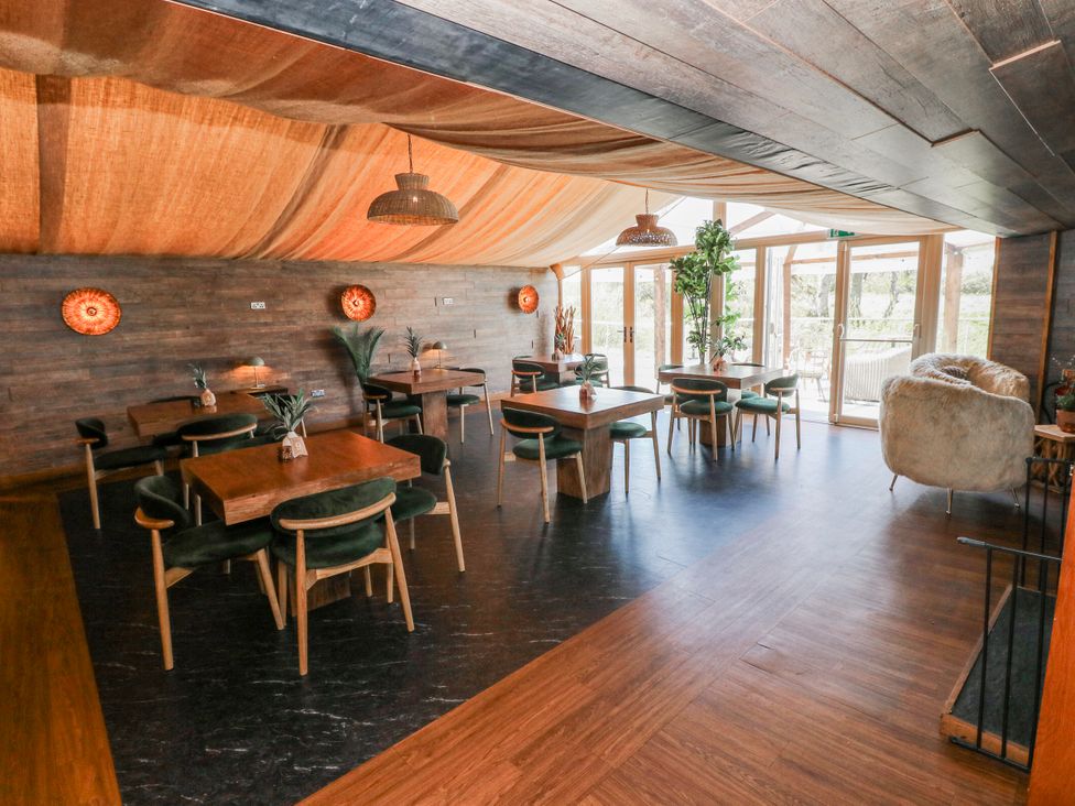 A dining room with tables and chairs at Glamping Pod 1, Oldwalls, Llanrhidian, Gower