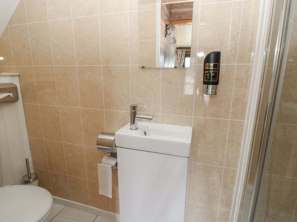 A bathroom with a sink and toilet at Garden Lodge 2 Swansea