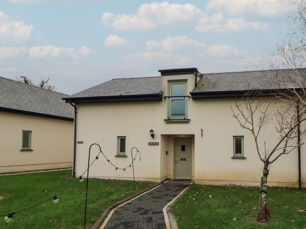 A house with a pathway and garden at Oak Tree Cottage in Swansea