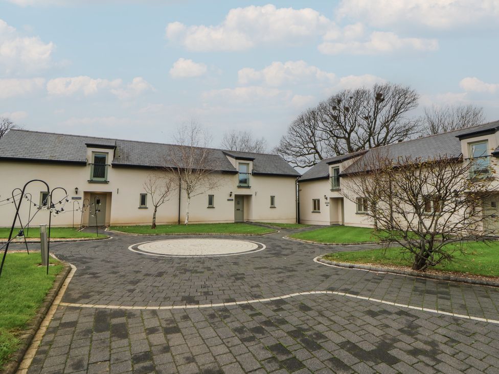 An outdoor area with houses and a circular driveway at Oak Tree Cottage in Swansea