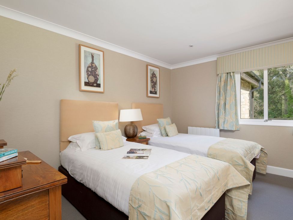 A bedroom with two single beds and a window at The Allensford in Slaley