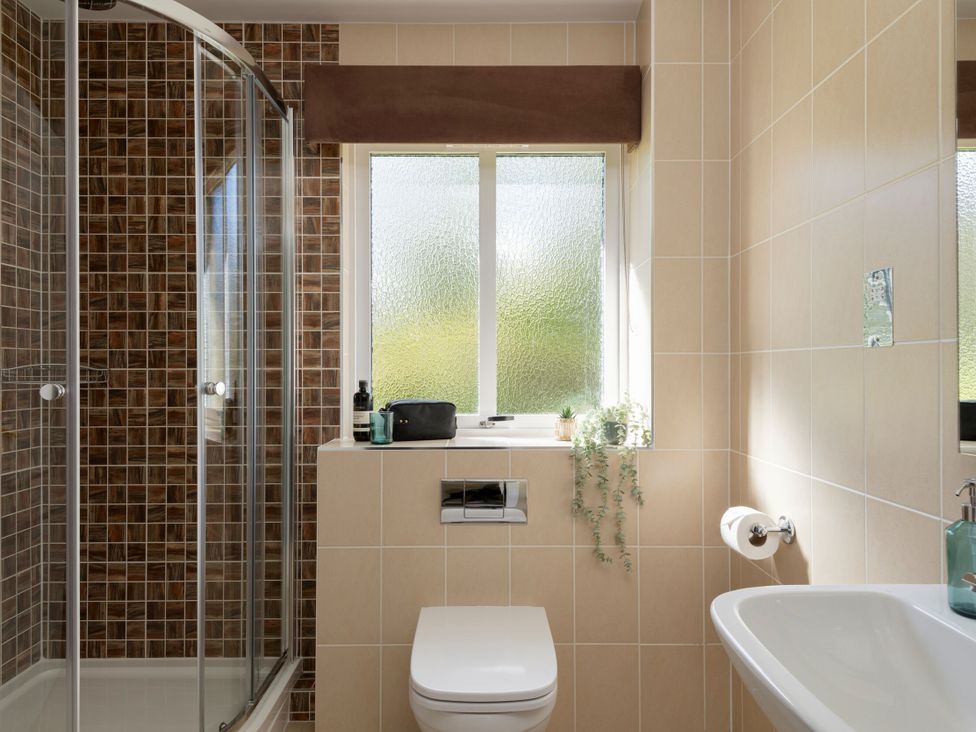 A bathroom with a shower, toilet and sink at The Allensford in Slaley
