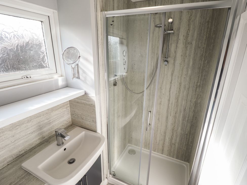 A bathroom with a shower and sink at No.49 Cherry Park Chapel St Leonards