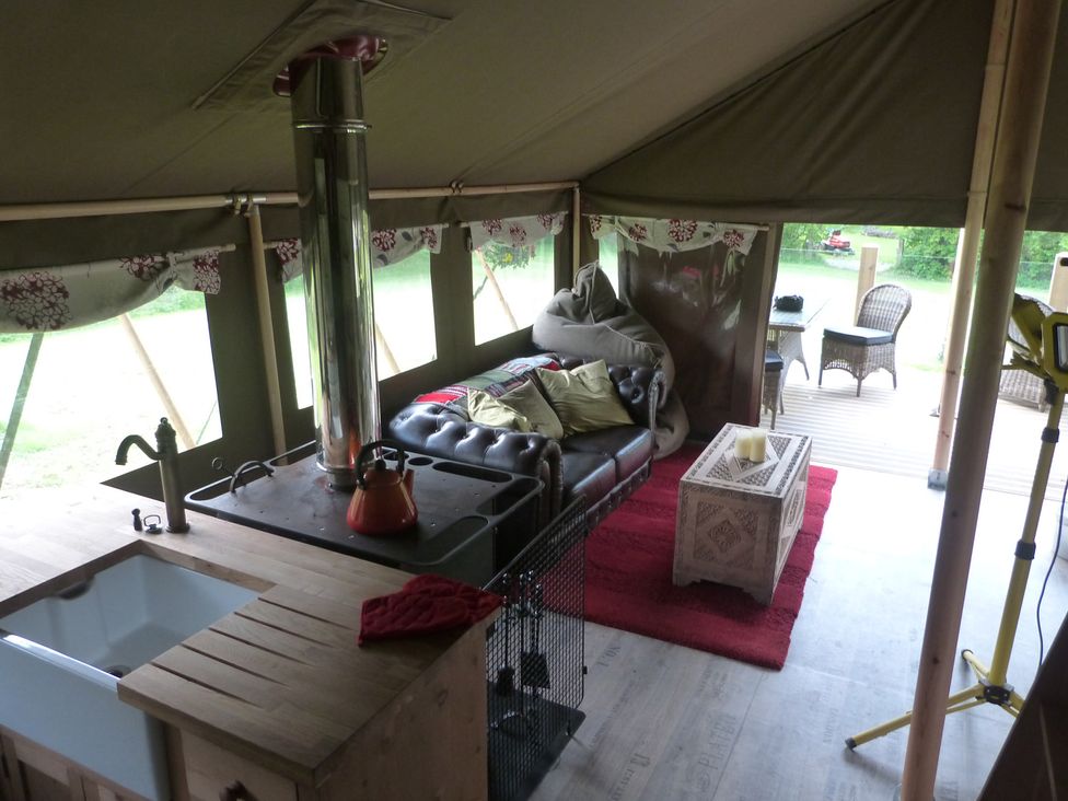 A tent with a sofa and stove in Ceri Newcastle Emlyn